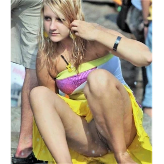 Sitting down in a short dress and accidentally showing her pussy