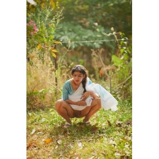 Seductive Desi woman lifts her saree and petticoat, squatting to relieve herself, and reveals her swollen pussy outdoors