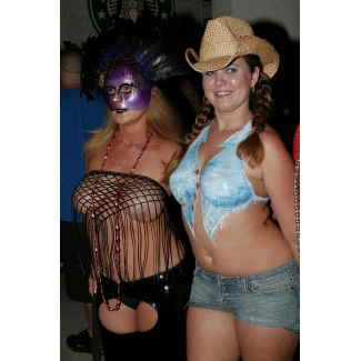 Two milfs with big boobs posing topless in a fishnet dress and body paint