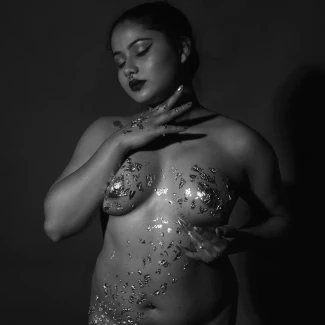 Desi milf having shiny paint artistically on her body and posing topless