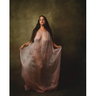 Erotic MILF revealing her massive breasts and bald cunt and posing almost nude in a transparent dress