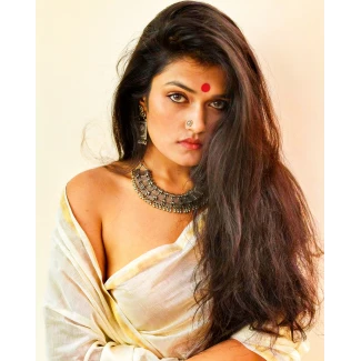 Desi model with bindi and silver jewelry in a braless saree but hiding her boobs