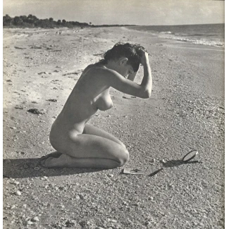 Nude woman with small round breasts kneeling on beach from Lucien Clergue