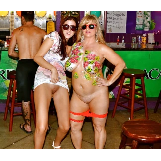 Almost nude milf in body paint exposing her big boobs and showing her pussy along with her friend