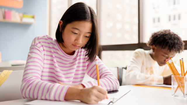 Student working at desk in a classroom