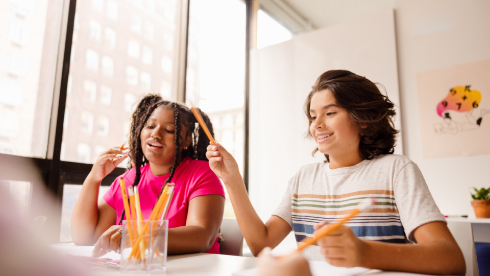 two middle school students are working on a math activity together