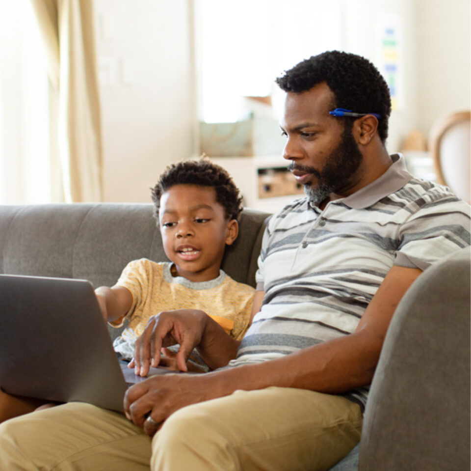 student-and-family-member-viewing-a-laptop-WF1958006