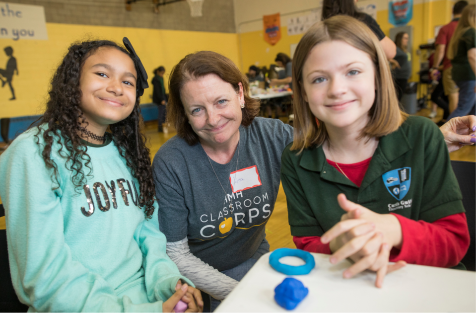 Volunteer with two students WF1755583
