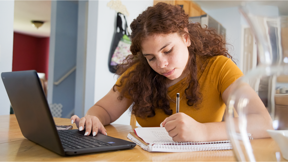 Student with a laptop doing homework