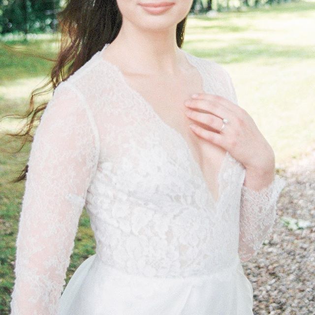 A woman in a lace dress with soft lighting for a romantic or bridal theme.
