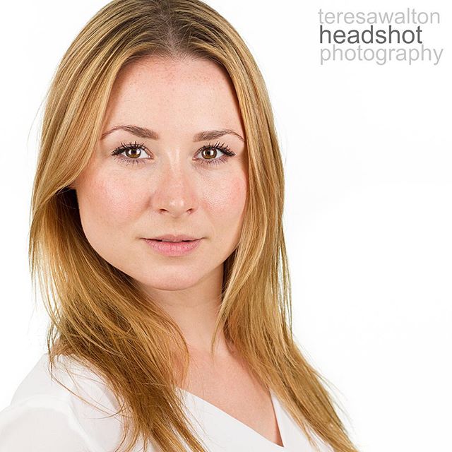 Professional headshot of a confident woman with blonde hair against a clean white background.