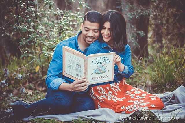A happy couple sits in a park, reading "Guess How Much I Love You: Autumn" together.
