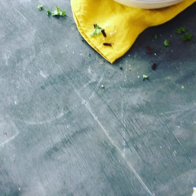 Overhead shot of cloves on a yellow cloth against a gray surface, ideal for culinary and food blogs.