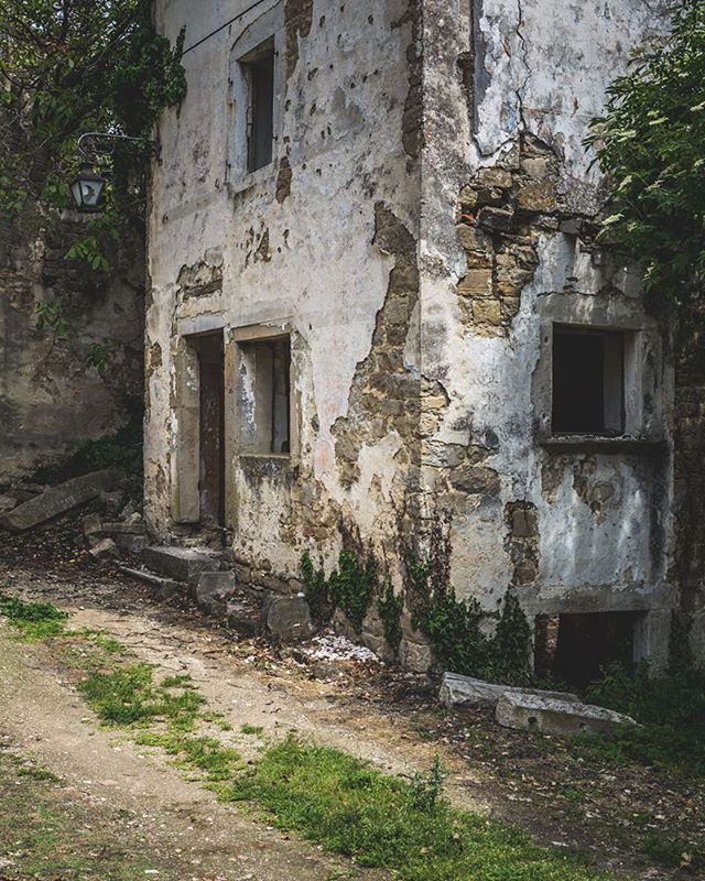An old, decaying building stands with crumbling walls and a rustic, abandoned charm in a forgotten landscape.