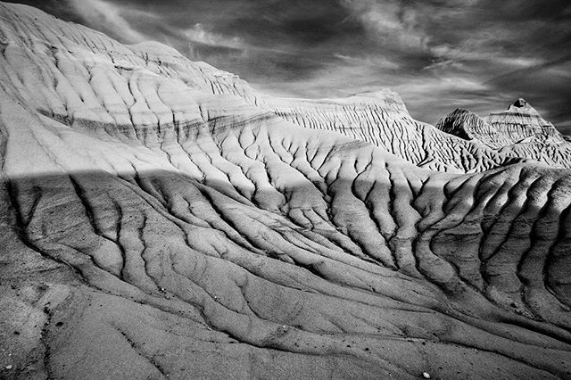 Monochrome landscape featuring the eroded badlands, showcasing nature's artistry and the passage of time.
