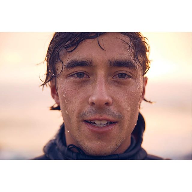 A wet, determined athlete gazes directly at the camera, embodying strength for fitness or hydration campaigns.