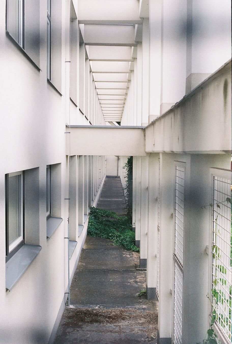 An architectural shot of a long hallway with pillars, offering a unique urban perspective.