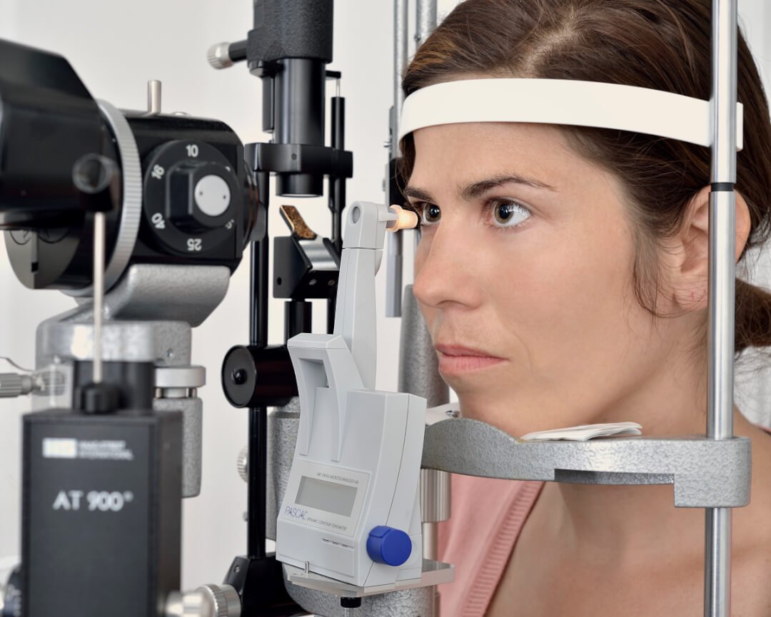 A woman undergoes an eye examination with a slit lamp, ensuring optimal vision and eye health.