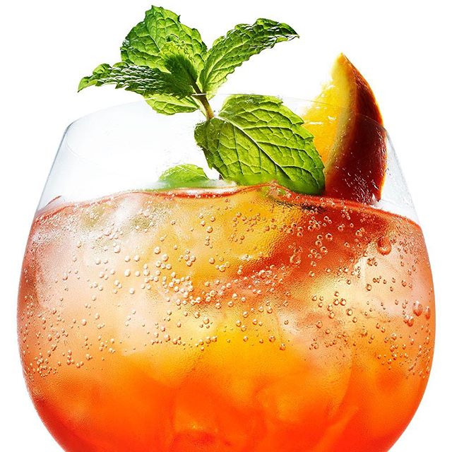 A refreshing Aperol Spritz cocktail with orange and mint in a glass, perfect for social media advertising.