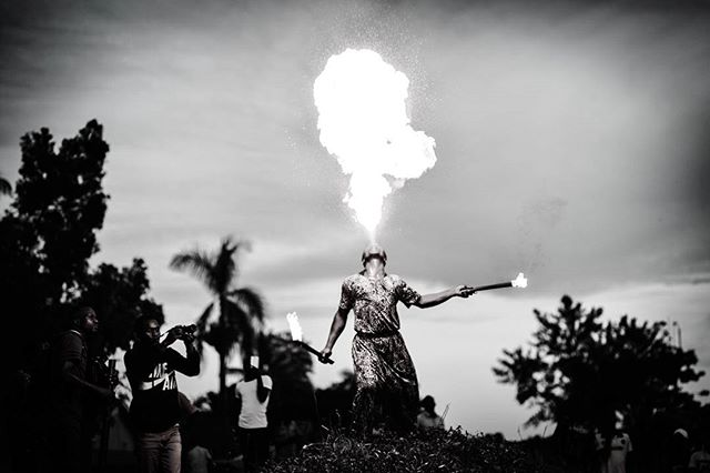 A fire breather performs in black and white.