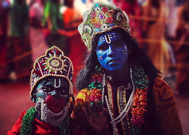 Two people in traditional Indian costumes at a cultural event, showcasing vibrant colors and heritage.