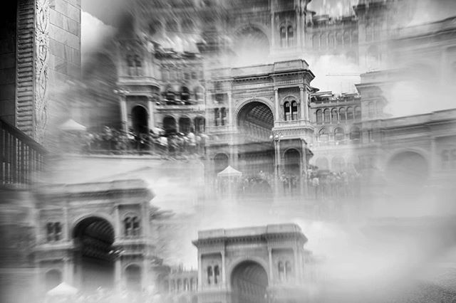 Abstract black and white view of Galleria Vittorio Emanuele II, Milan. A blurred and dreamy vision of iconic architecture.