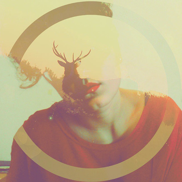 Artistic double exposure portrait of a woman with a deer silhouette, creating a dreamy and surreal visual.