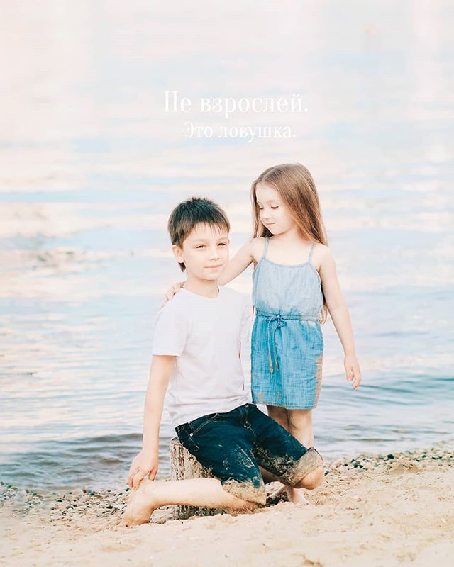 A brother and sister pose lovingly at the beach, creating a tender moment captured in soft, natural light.