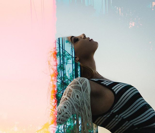A woman gazes upward in a surreal double exposure of nature, blending the figure with an ethereal forest scene.
