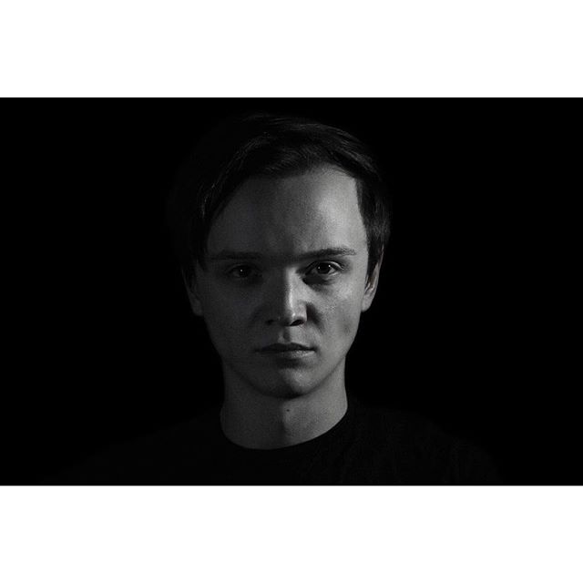 Monochrome portrait of a man with soft lighting against a dark background, ideal for professional profiles.