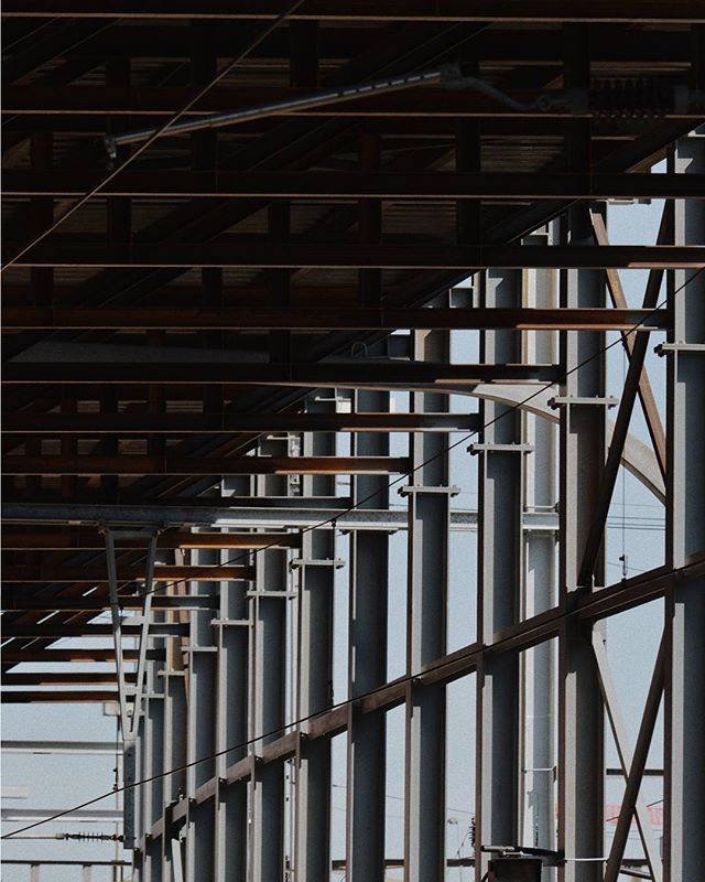 An abstract view of a building under construction with metal beams and pillars, in a modern and geometric style.