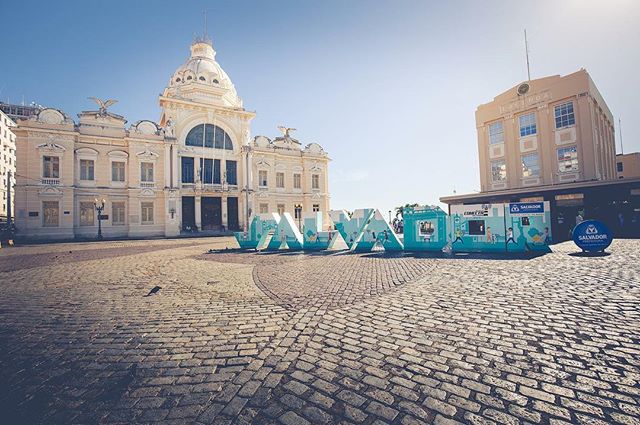 Scenic view of Salvador, Bahia city square featuring iconic letters, showcasing architectural buildings under a clear sky.