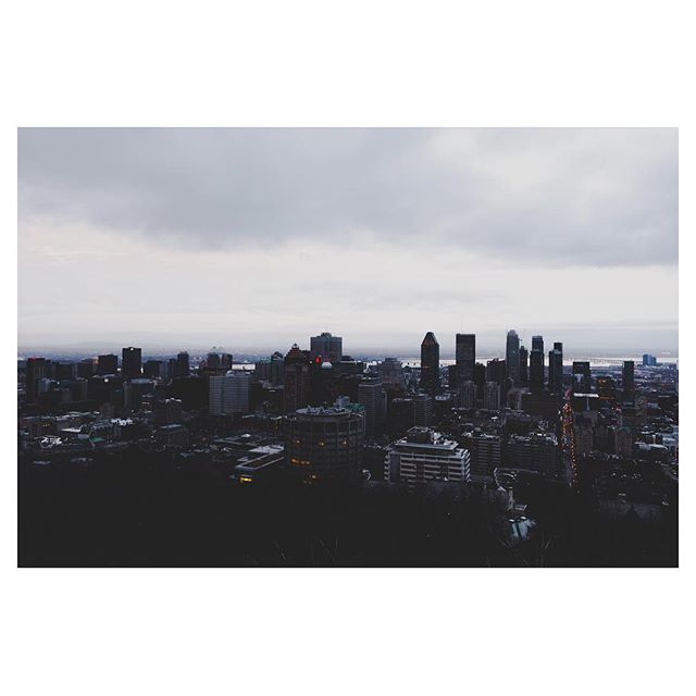 A cityscape featuring skyscrapers under an overcast sky conveys a moody and modern urban scene.