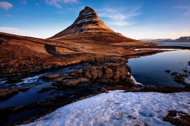 Kirkjufell mountain and waterfalls create a tranquil landscape in Iceland. 