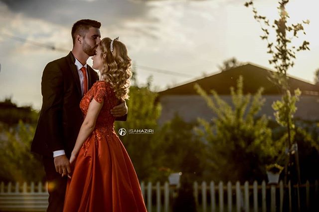 A loving couple embracing in a romantic wedding scene.