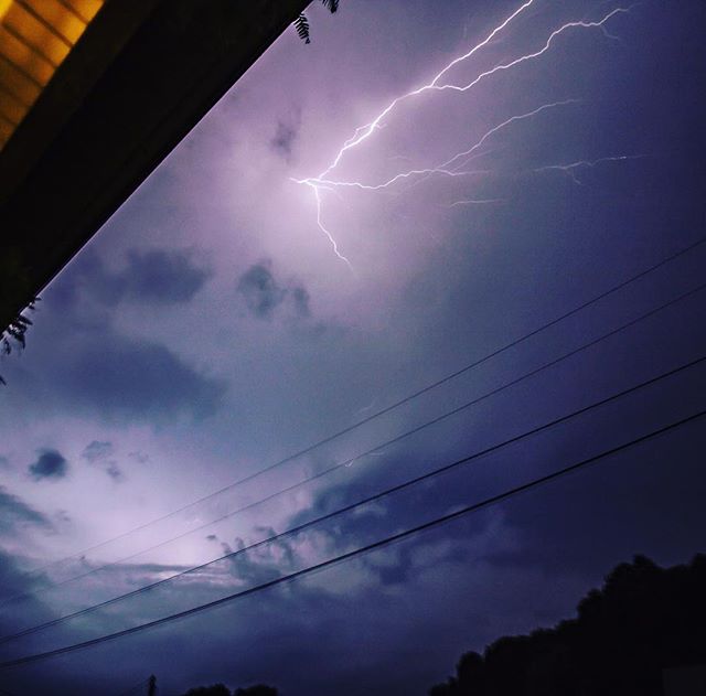Dramatic lightning storm illuminates the night sky with electric energy and moody hues.