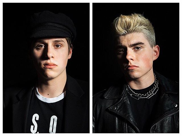 A modern portrait featuring two young men against a black background. Ideal for fashion or music campaigns.