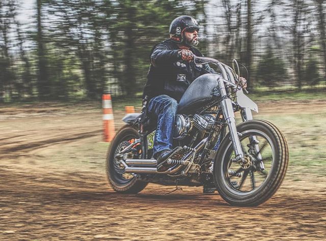 A man rides a motorcycle on a dirt track, showcasing action and outdoor recreation.