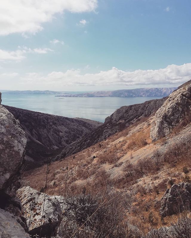 Scenic mountain landscape overlooking the sea on a clear day. Nature and travel concept.