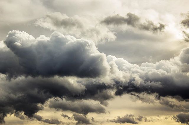 Dramatic clouds fill the sky, creating a moody and atmospheric scene, ideal for backgrounds and weather-related content.