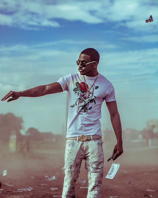 A stylish man throws money in the air, showcasing a confident and luxurious lifestyle.