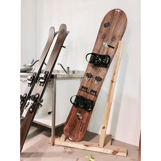 A snowboard and pair of skis are propped against the wall, showing a winter sports equipment.