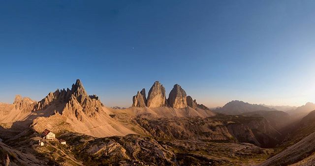 Scenic view of Tre Cime di Lavaredo mountain range in the Dolomites under a clear blue sky.