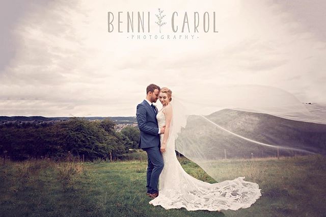 A bride and groom embrace in a romantic outdoor wedding photo with a soft, dreamy aesthetic.