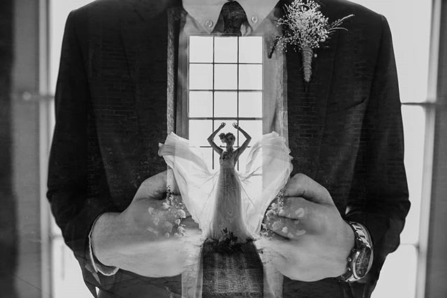 A double exposure image of a groom holding a bride dancing in a window. 