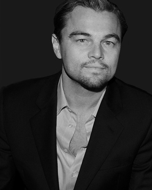 A black and white portrait of Leonardo DiCaprio in a suit. Ideal for editorial or celebrity-focused content.