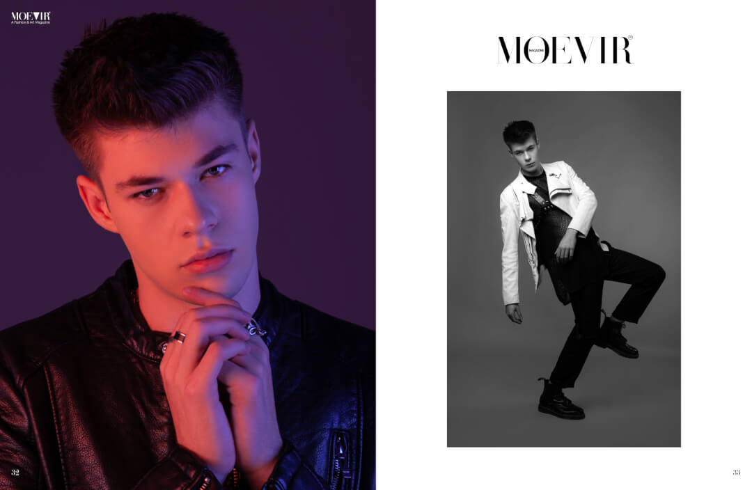 A fashionable man poses in a studio, showcasing modern menswear in a high-fashion editorial.