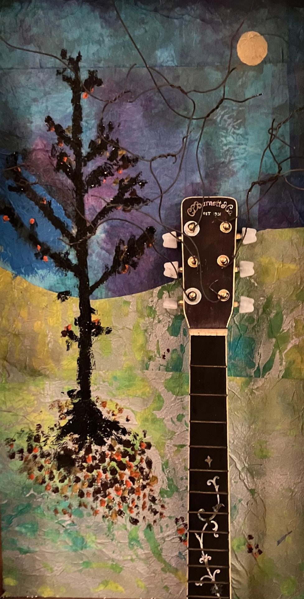 Artwork by Charlie Barnett, featuring the neck of an old banjo against a painted background featuring a tree that has dropped its leaves. The predominant colors are blue and brown.