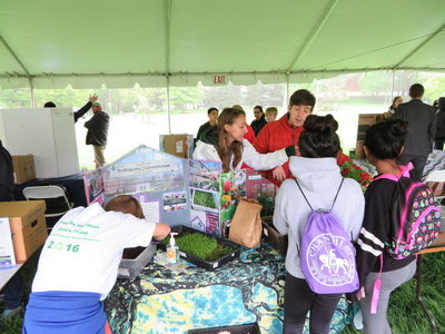Environmental communication students share information with children attend the showcase