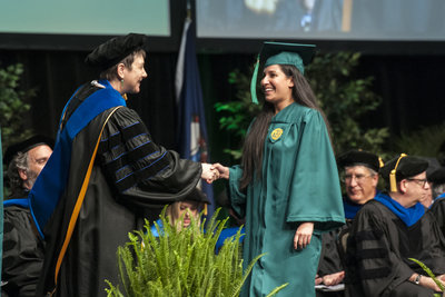 Dean Deborah Boehm-Davis offers congratulations to a new graduate.  
